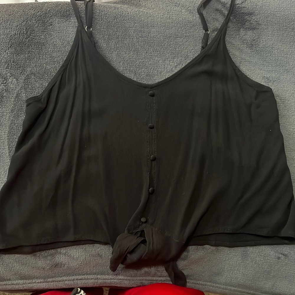 Black flowing tank top with buttons and tie at bottom